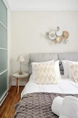 a bedroom with a large white bed and a table at Acropolis Memories in Athens