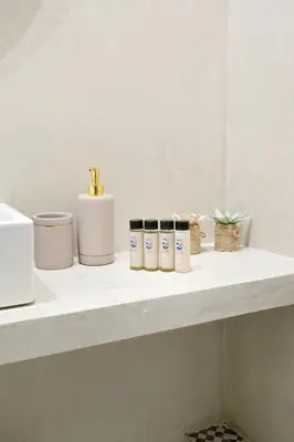 a shelf with five containers on it in a bathroom at Acropolis Memories in Athens