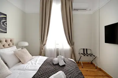 a bedroom with a bed with a teddy bear on it at Acropolis Memories in Athens