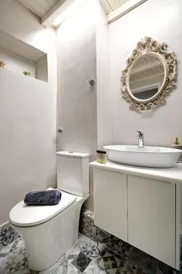 a white bathroom with a toilet and a sink at Acropolis Memories in Athens