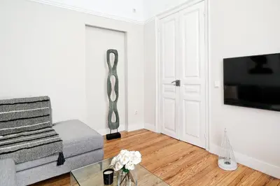 a living room with a couch and a tv at Acropolis Memories in Athens