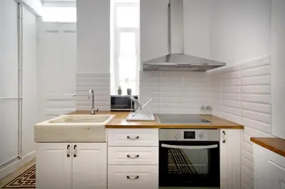 a white kitchen with a sink and a stove at Acropolis Memories in Athens