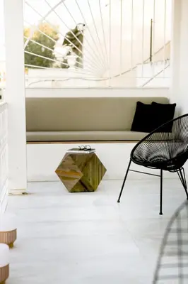 a chair and a table in a room with a window at Bluscapes Home in Athens