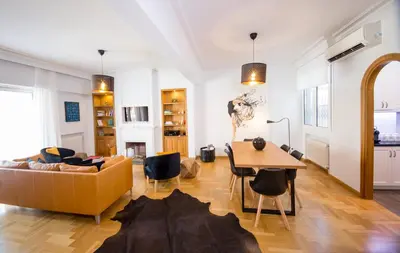 a living room with a couch and a table at Bluscapes Home in Athens