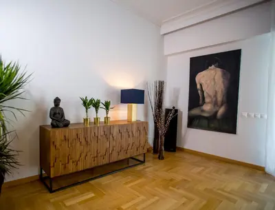 a living room with a table with a statue on it at Bluscapes Home in Athens