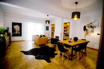 a living room with a table and a couch at Bluscapes Home in Athens
