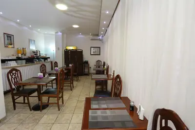 a row of tables and chairs in a restaurant at Athens Delta Hotel in Athens