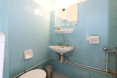 a blue bathroom with a sink and a toilet at Athens Delta Hotel in Athens