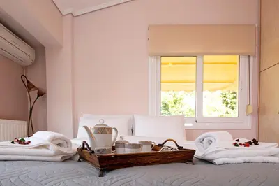 a bed with towels and a tray of food on it at Nostalgia Seaview House in Anavissos