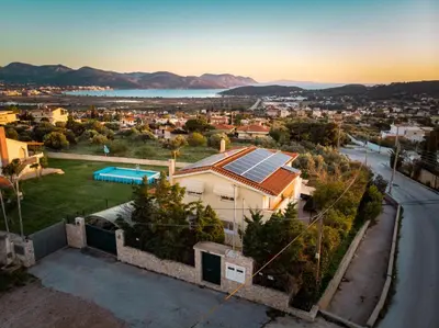 a house with solar panels on the roof at Nostalgia Seaview House in Anavissos