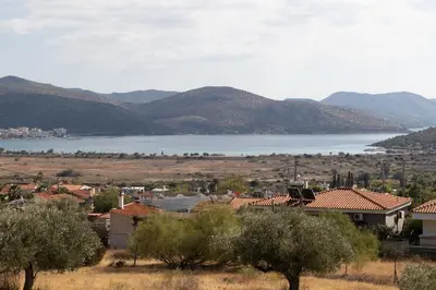a view of a town with a lake and mountains at Nostalgia Seaview House in Anavissos