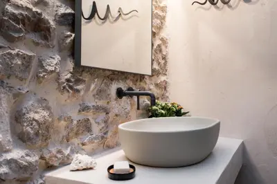 a bathroom with a bowl sink on a counter at Nest in Athens