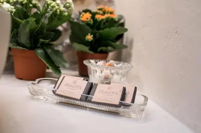 a bar of soap in a holder on a shelf with flowers at Nest in Athens