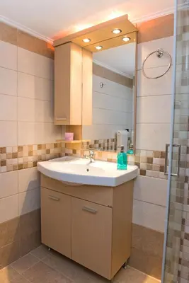 a bathroom with a sink and a mirror at Lianos Apartments Business Class A in Piraeus