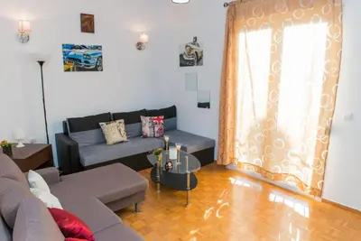 a living room with a couch and a table at Lianos Apartments Business Class A in Piraeus