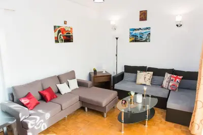 a living room with a couch and a table at Lianos Apartments Business Class A in Piraeus