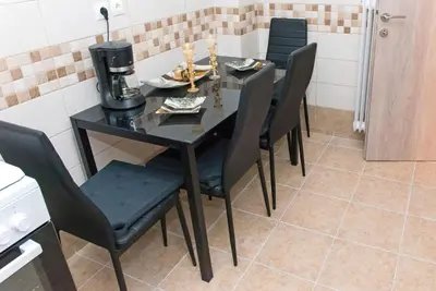 a black dining room table with black chairs at Lianos Apartments Business Class A in Piraeus