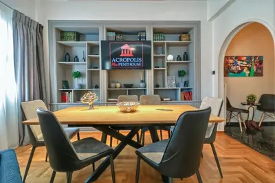 a dining room with a table and chairs at Acropolis Plus Penthouse in Athens