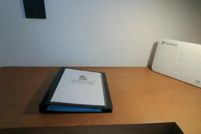 a book sitting on a table next to a laptop at Acropolis Plus Penthouse in Athens