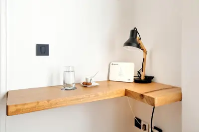 a wooden shelf with a lamp and a clock on it at Acropolis Plus Penthouse in Athens
