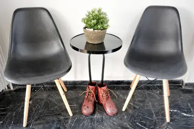 two black chairs and a table with a potted plant at Acropolis Plus Penthouse in Athens