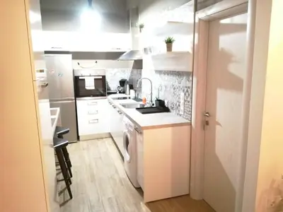 a kitchen with white cabinets and a sink at Athens city center cozy apartment in Athens