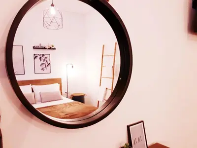 a bedroom with a mirror on the wall at Athens city center cozy apartment in Athens