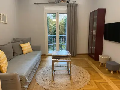 a living room with a couch and a table at Charming 1bd Apt at Concert Hall in Athens