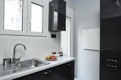 a kitchen with a sink and a bowl of fruit at Charming 1bd Apt at Concert Hall in Athens