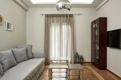a living room with a couch and a table at Charming 1bd Apt at Concert Hall in Athens
