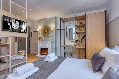 a bedroom with a white bed and a fireplace at The Pinnacle Athens in Athens