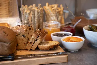 a table with a cutting board with bread and other foods at The Pinnacle Athens in Athens