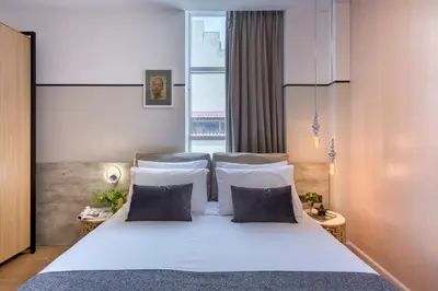 a bedroom with a white bed and a large window at The Pinnacle Athens in Athens
