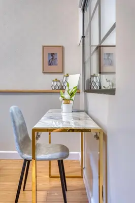a desk with a chair and a vase on it at The Pinnacle Athens in Athens