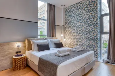 a bedroom with a large bed and a large window at The Pinnacle Athens in Athens