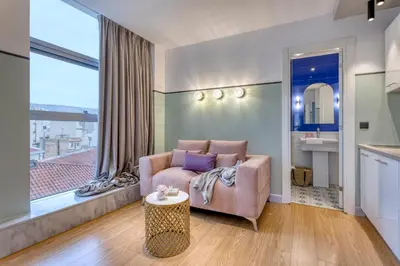 a living room with a couch and a table at The Pinnacle Athens in Athens