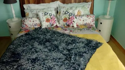 a bed with pillows and a blanket on it at Athens riviera modern and elelegant flat 500 metres from VOULA beach in Athens