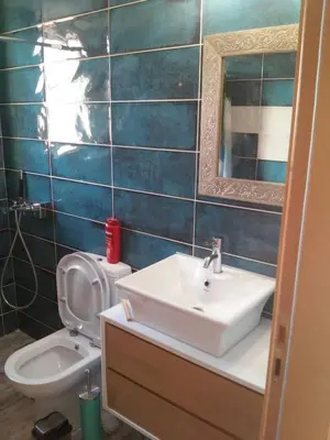 a bathroom with a sink and a toilet and a mirror at Athens riviera modern and elelegant flat 500 metres from VOULA beach in Athens