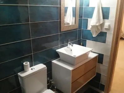 a bathroom with a white sink and a toilet at Athens riviera modern and elelegant flat 500 metres from VOULA beach in Athens