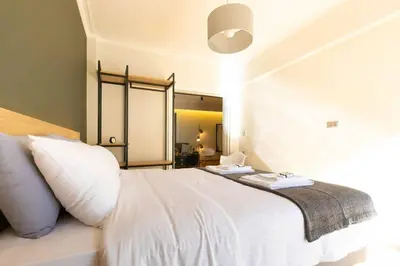 a bedroom with a white bed and a mirror at TONI'S 