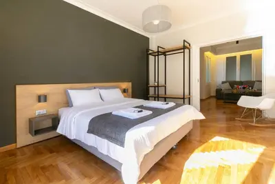 a bedroom with a large bed and a living room at TONI'S 