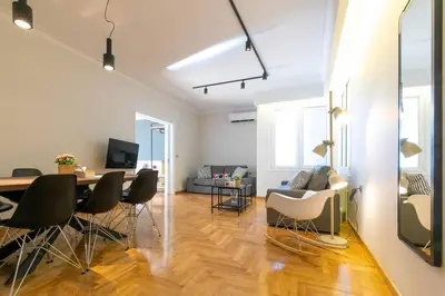 a living room with a dining room table and chairs at TONI'S 