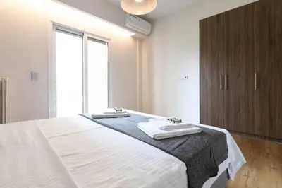 a bedroom with a bed with two towels on it at TONI'S Cute 2BD Apartment in Koukaki! in Athens
