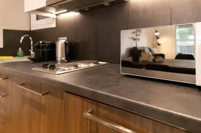 a kitchen with a counter top with a microwave at TONI'S Cute 2BD Apartment in Koukaki! in Athens
