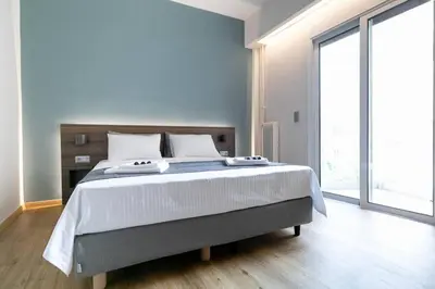 a bedroom with a large bed and a large window at TONI'S Cute 2BD Apartment in Koukaki! in Athens