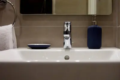 a bathroom sink with a blue bowl and a faucet at TONI'S Fashionable Studio near Presidential Garden in Athens