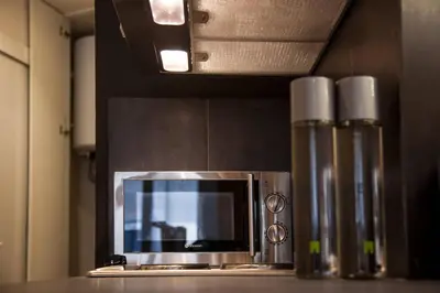a microwave sitting on top of a kitchen counter at TONI'S Fashionable Studio near Presidential Garden in Athens