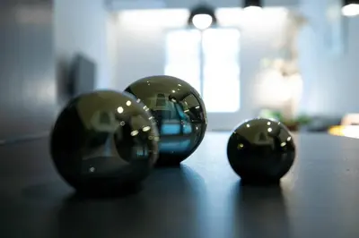 three black spheres sitting on top of a table at TONIS Le Petit Nicolas 1BD Apartment in Koukaki! in Athens