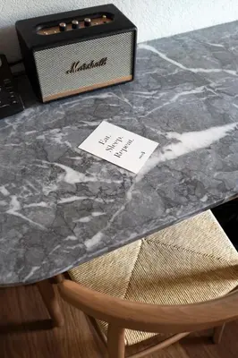 a marble table with a box on top of a chair at Ergon House Athens in Athens