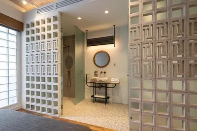 a bathroom with a glass door leading to a sink at Ergon House Athens in Athens